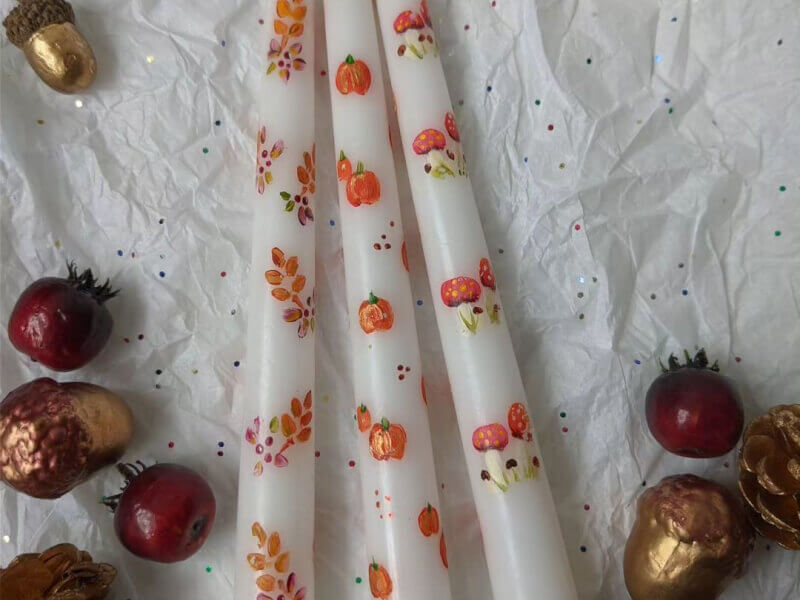 Pillar candles painted with autumn themed images.